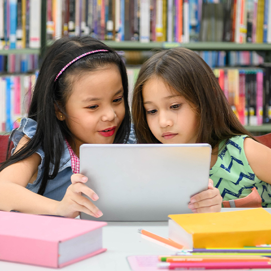 Two girls playing on a tablet